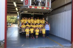 kids in front of fire truck during visit